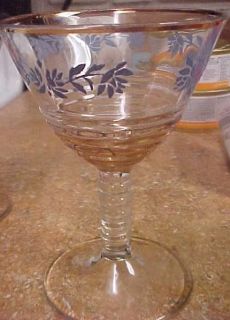 & wine glasses w/blue flowers and gold rings & rim. unknown maker